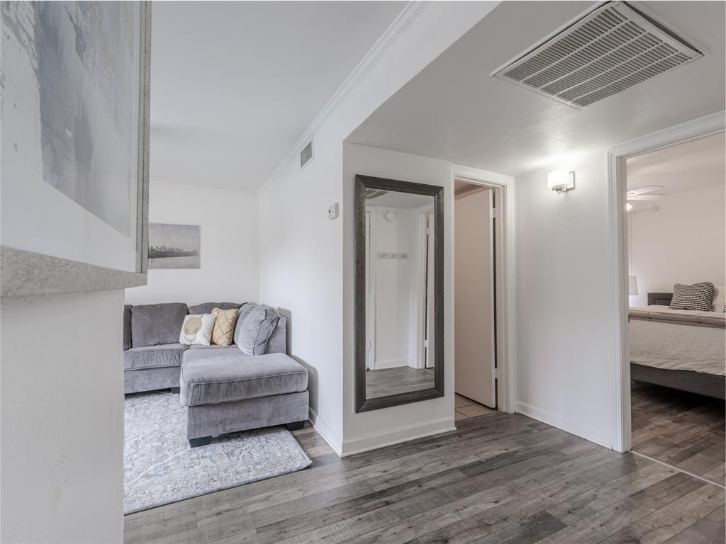 4748 Old Bent Tree Lane, Unit 201 Dallas, TX 75287 - Photo 3 of 17 Hall featuring wood finished floors and ornamental molding
