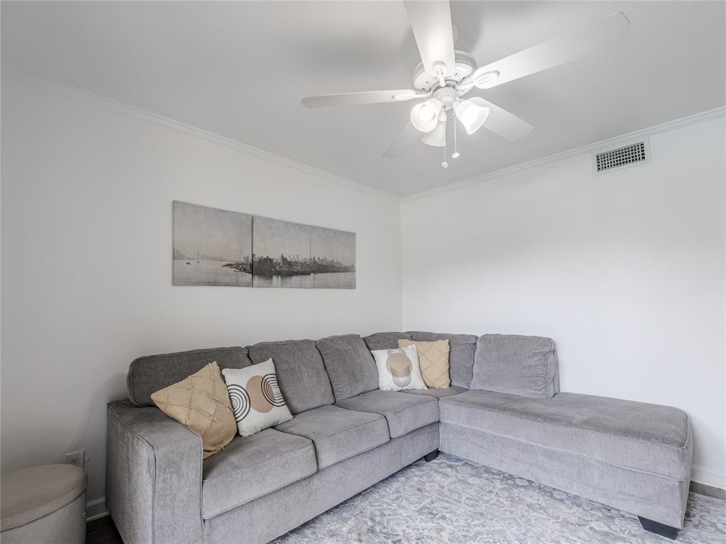 4748 Old Bent Tree Lane, Unit 201 Dallas, TX 75287 - Photo 4 of 17 Living area featuring crown molding and a ceiling fan
