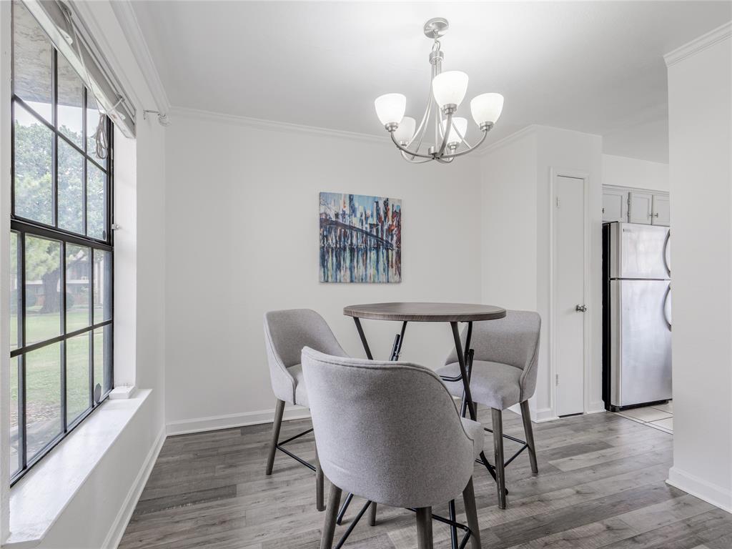 4748 Old Bent Tree Lane, Unit 201 Dallas, TX 75287 - Photo 9 of 17 Dining area with crown molding, light wood-style flooring, and a chandelier