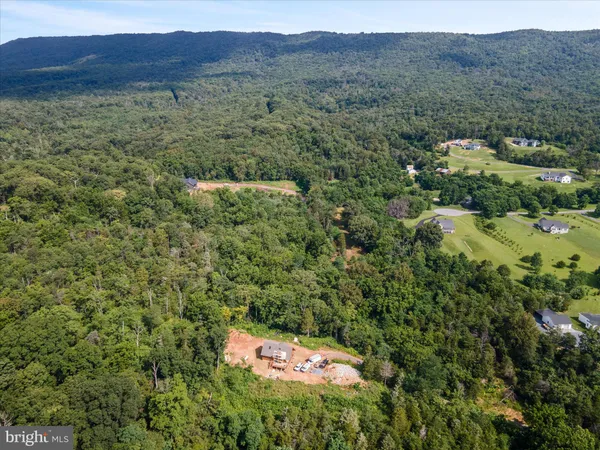 a view of a lush green hillside and a building