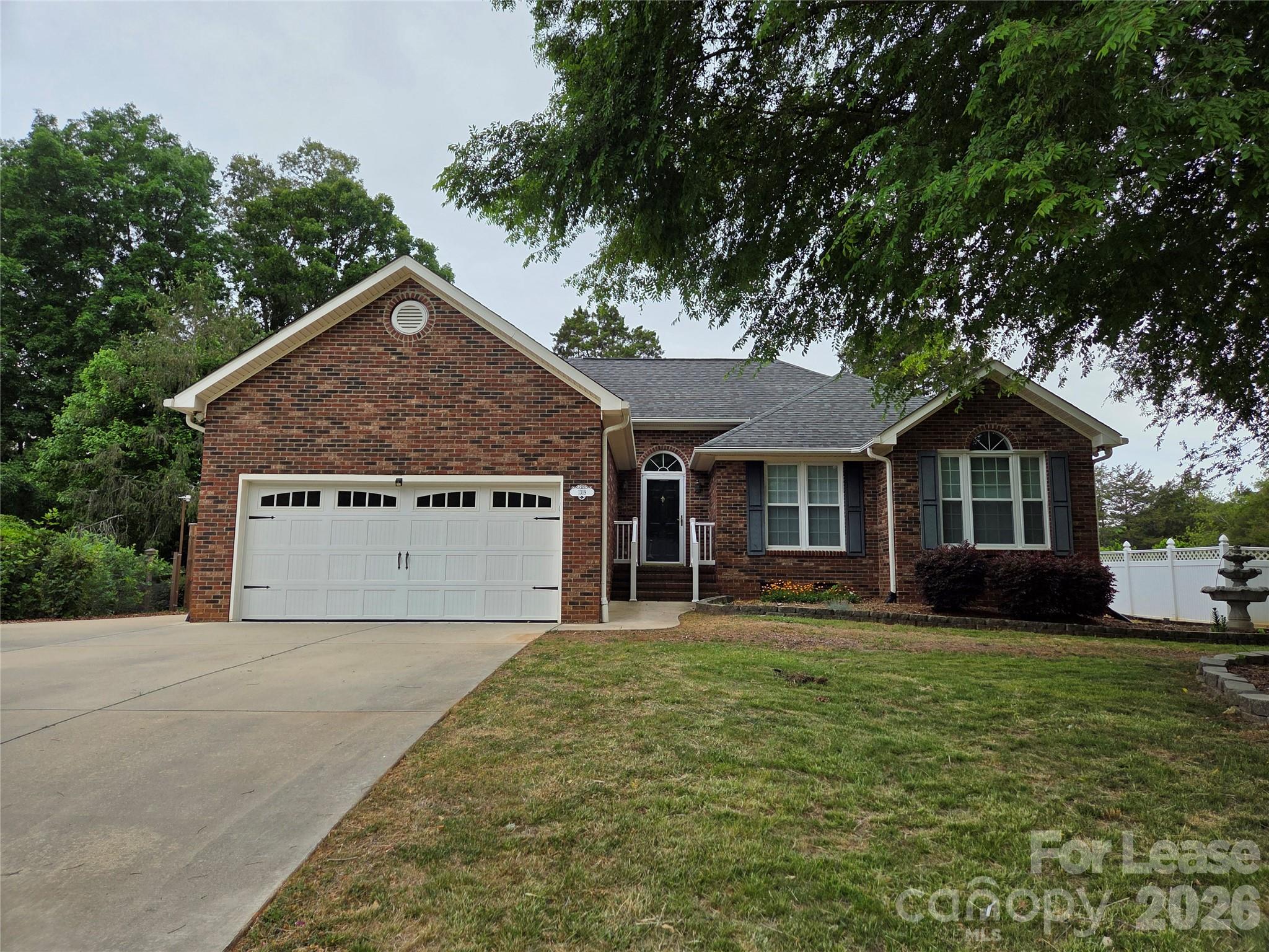 1319 Mistletoe Ridge Place Northwest Concord, NC 28027 - Photo 1 of 35 a front view of a house with a garden