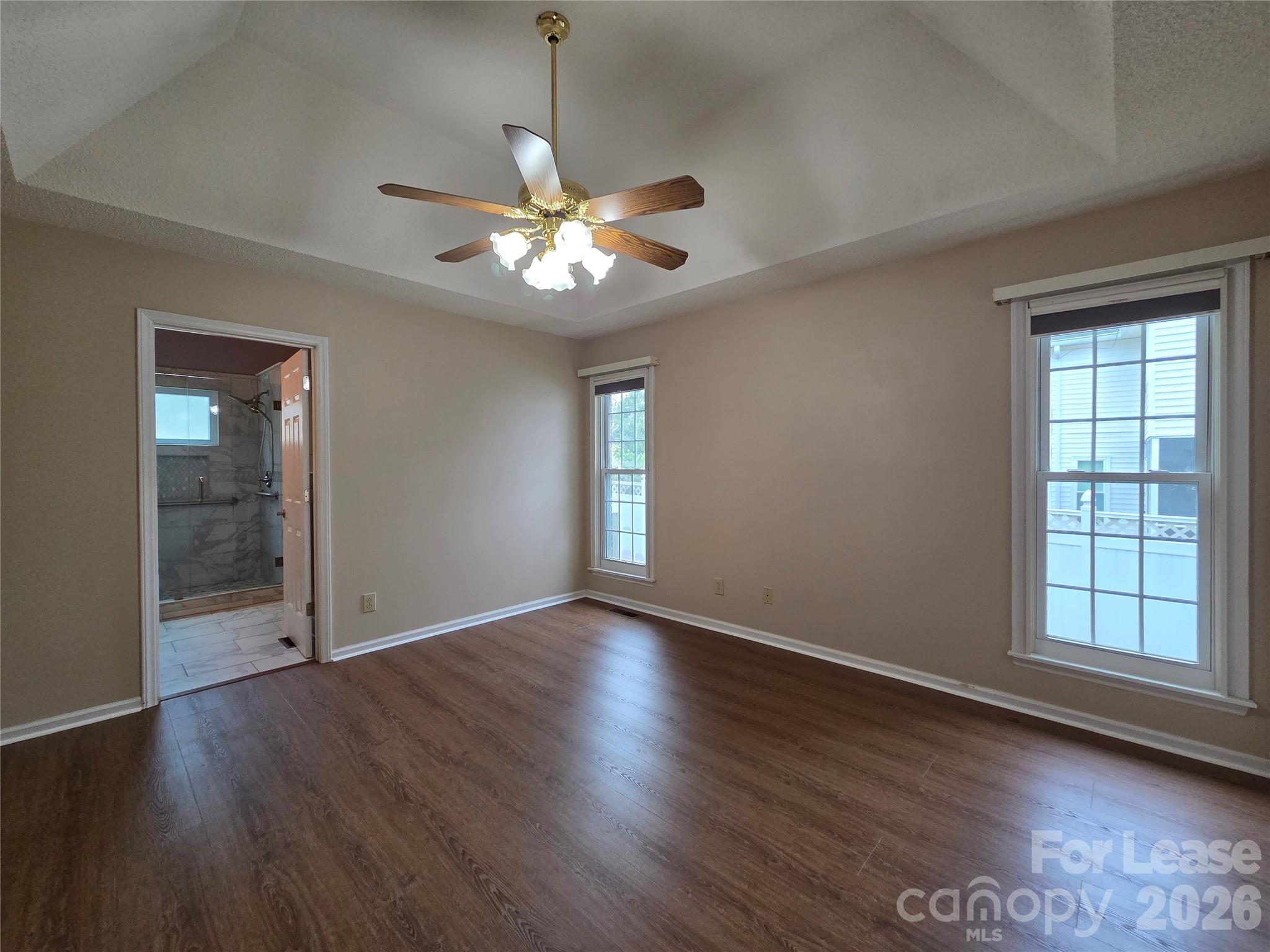 1319 Mistletoe Ridge Place Northwest Concord, NC 28027 - Photo 15 of 35 an empty room with wooden floor chandelier fan and windows