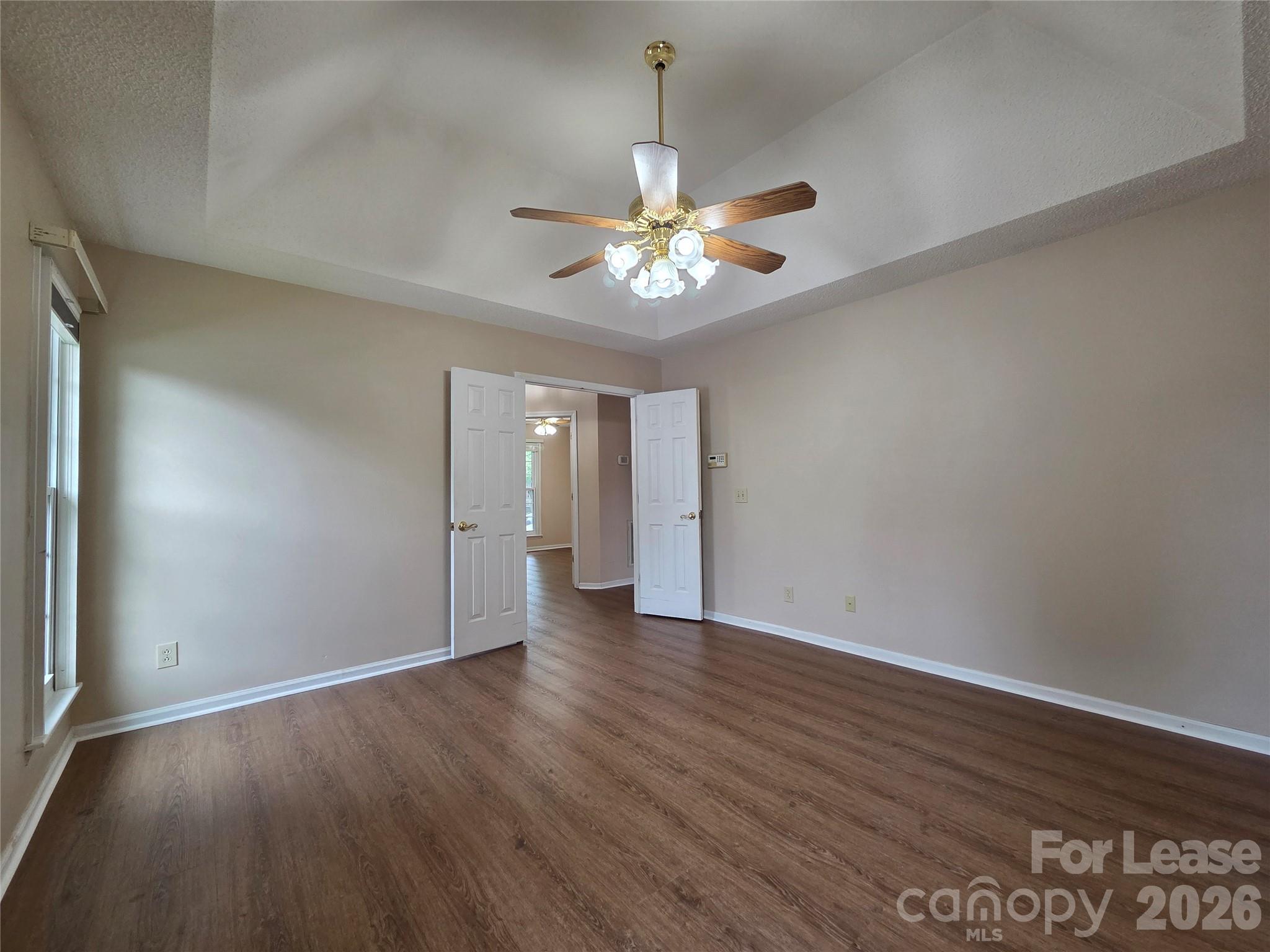 1319 Mistletoe Ridge Place Northwest Concord, NC 28027 - Photo 16 of 35 a view of an empty room with chandelier fan and wooden floor