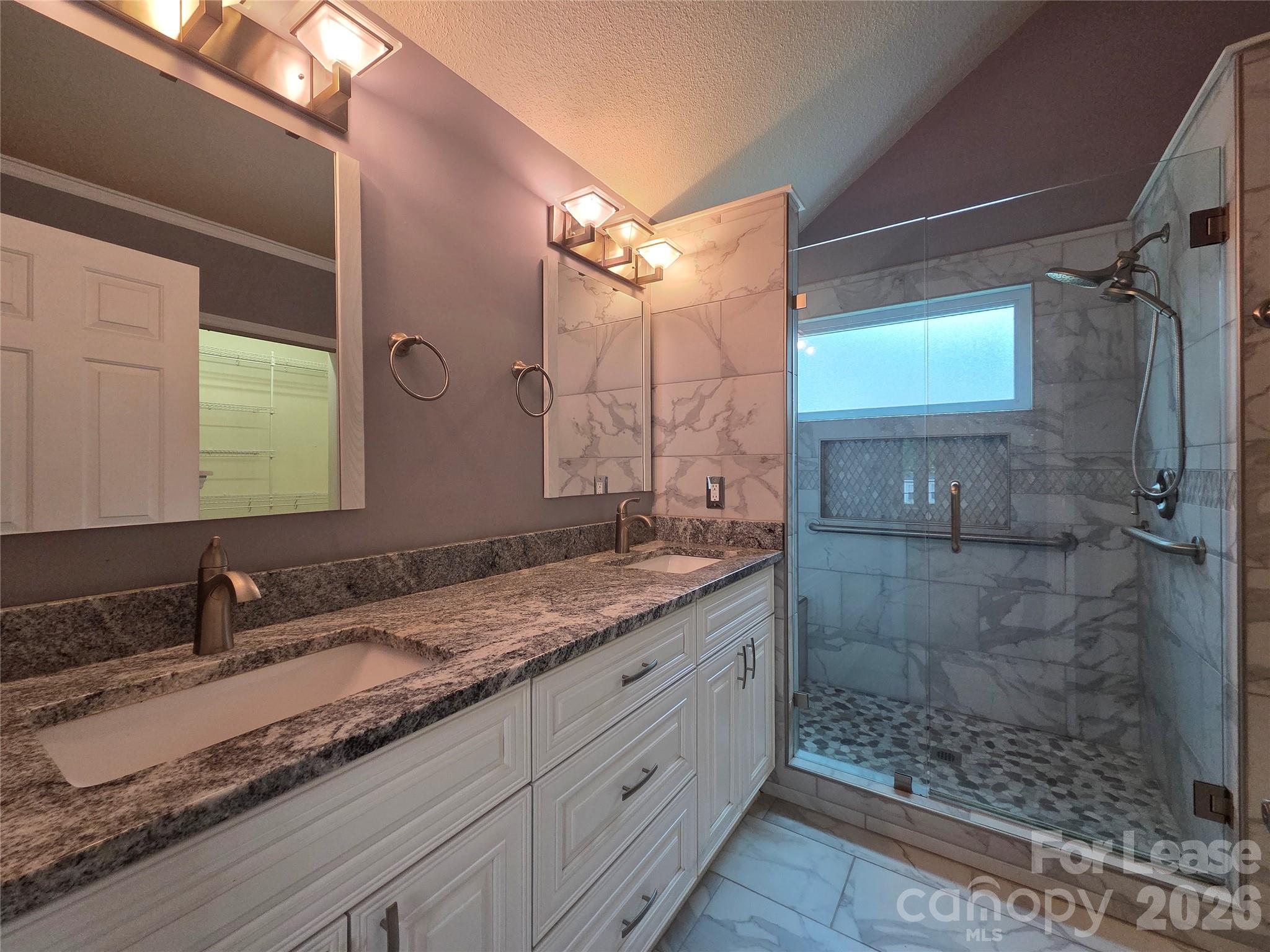 1319 Mistletoe Ridge Place Northwest Concord, NC 28027 - Photo 18 of 35 a bathroom with a granite countertop sink a mirror and shower