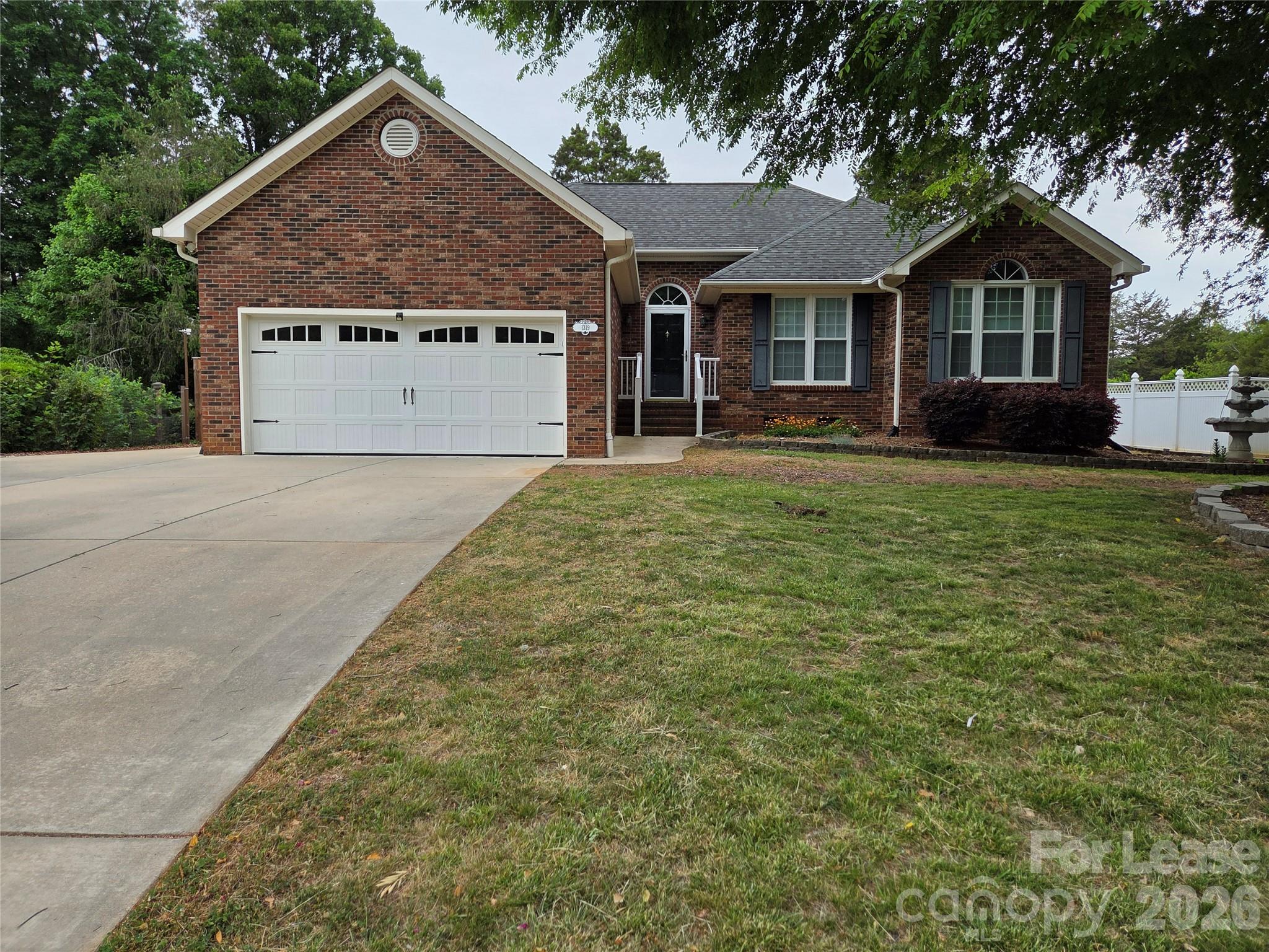 1319 Mistletoe Ridge Place Northwest Concord, NC 28027 - Photo 2 of 35 a front view of a house with a yard and garage
