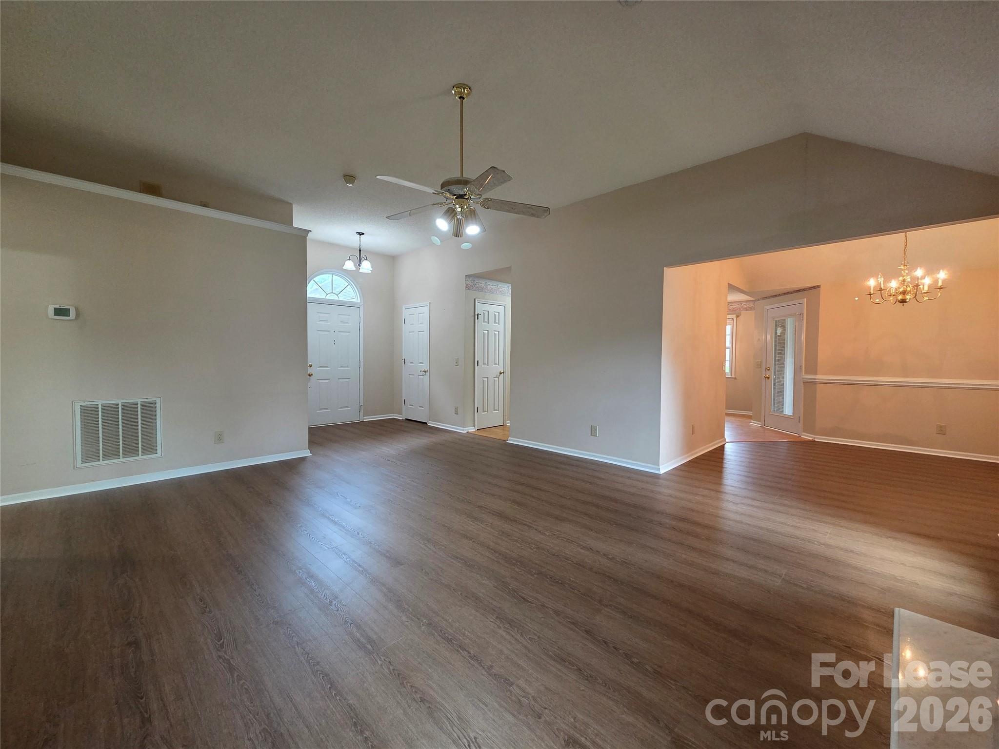 1319 Mistletoe Ridge Place Northwest Concord, NC 28027 - Photo 6 of 35 an empty room with wooden floor and windows