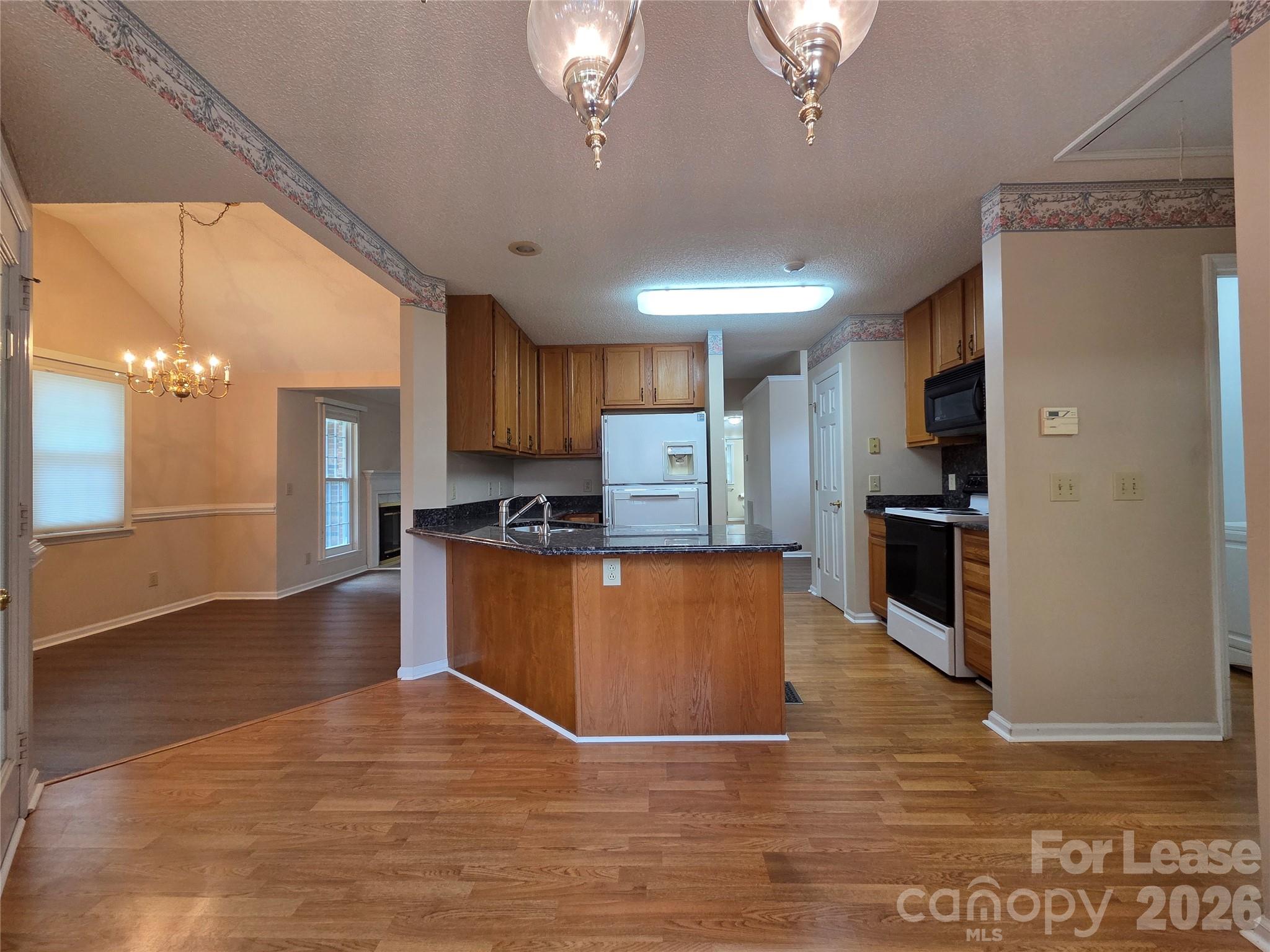 1319 Mistletoe Ridge Place Northwest Concord, NC 28027 - Photo 8 of 35 a large kitchen with stainless steel appliances granite countertop a refrigerator a stove top oven a sink and dishwasher