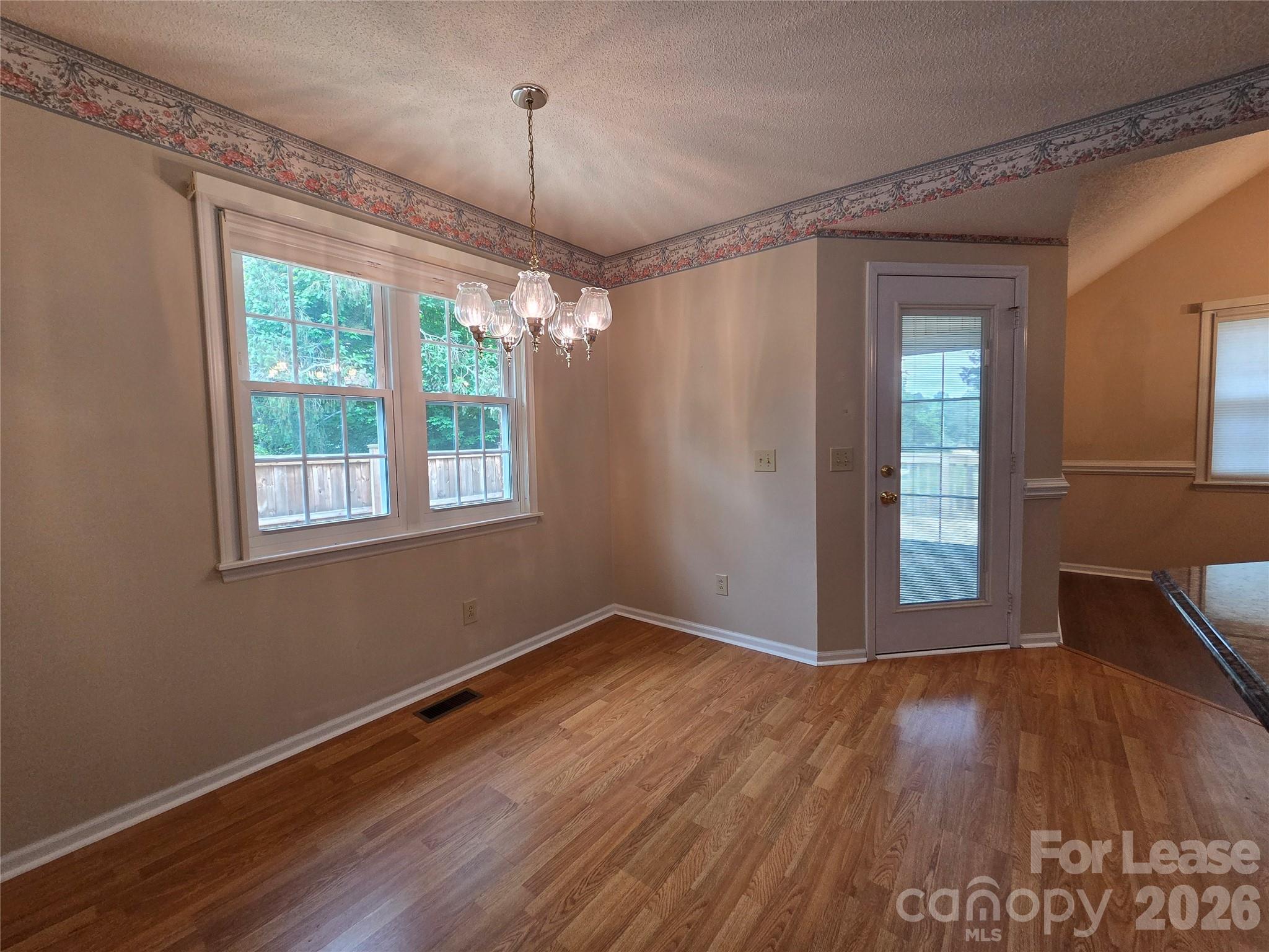 1319 Mistletoe Ridge Place Northwest Concord, NC 28027 - Photo 10 of 35 an empty room with wooden floor fan and windows