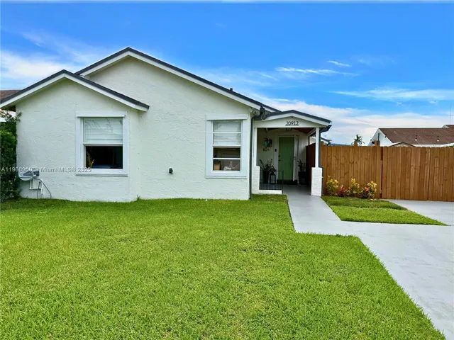 a view of a backyard with potted plants