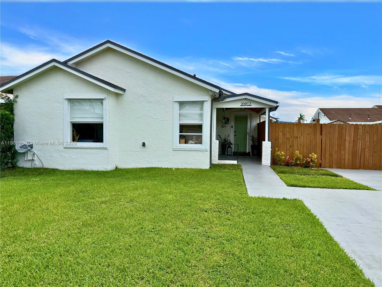 a view of a backyard with potted plants