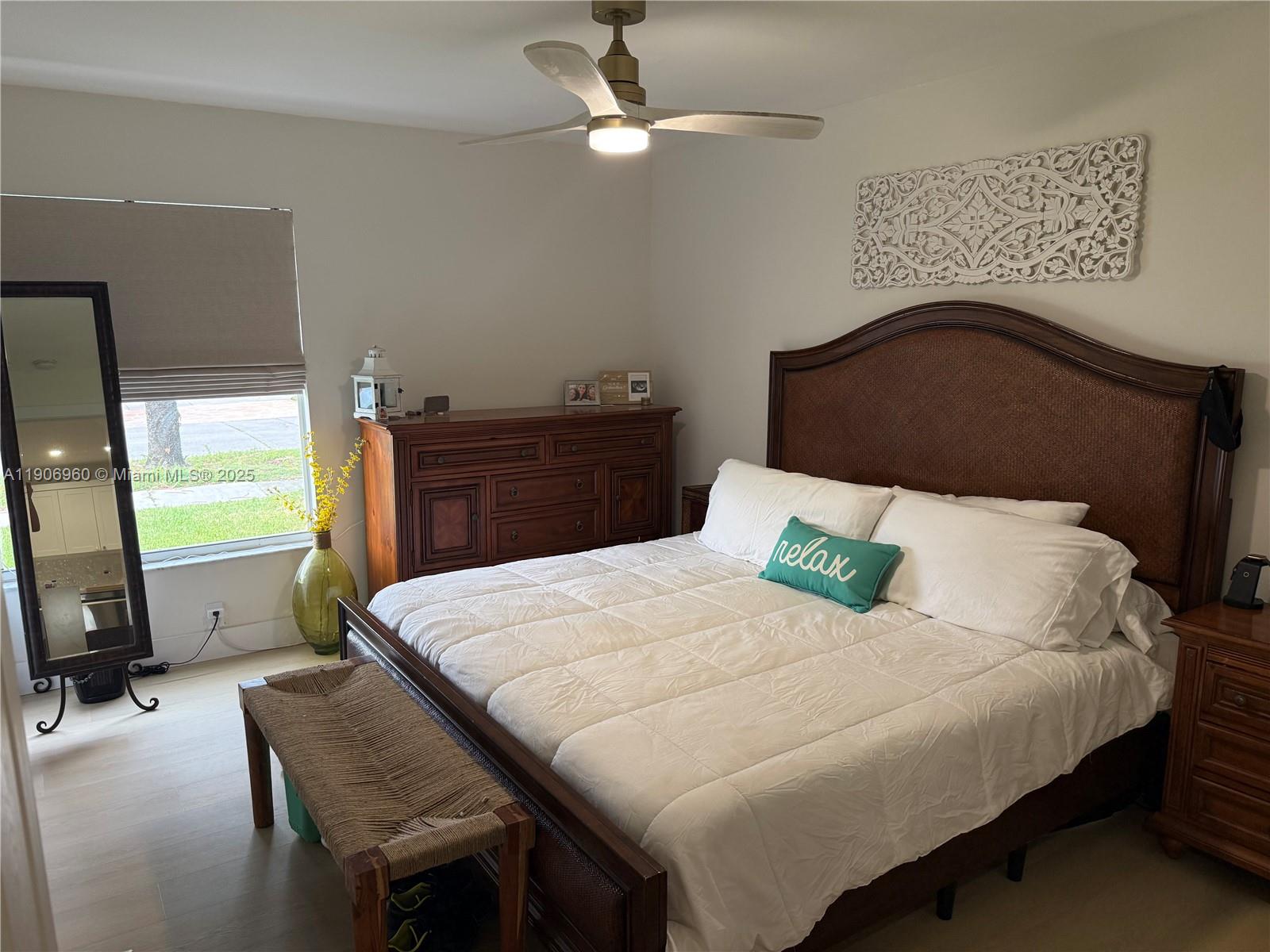 20912 Southwest 125th Avenue Road Miami, FL 33177 - Photo 13 of 25 a bedroom with a bed and a chandelier