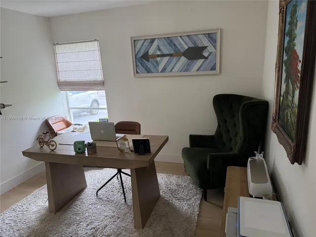 a work room with furniture and wooden floor