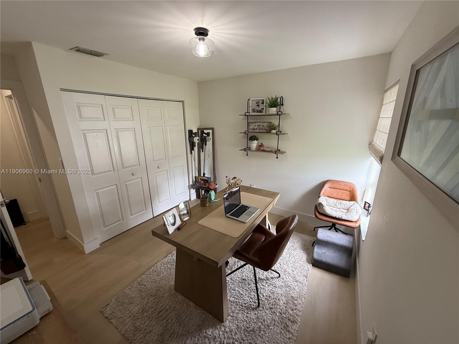 20912 Southwest 125th Avenue Road Miami, FL 33177 - Photo 16 of 25 a view of a workspace with furniture and a gate