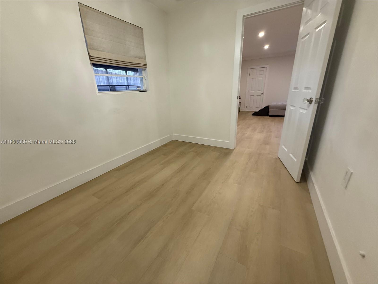 20912 Southwest 125th Avenue Road Miami, FL 33177 - Photo 17 of 25 a view of a room with wooden floor and a window