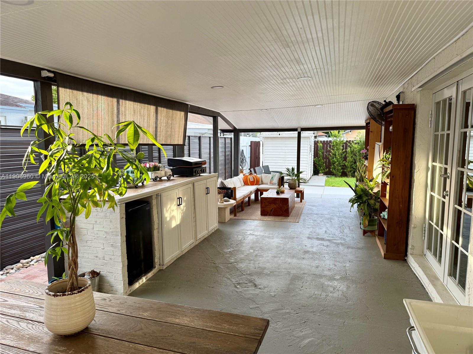 20912 Southwest 125th Avenue Road Miami, FL 33177 - Photo 18 of 25 a living room with patio furniture and a potted plant