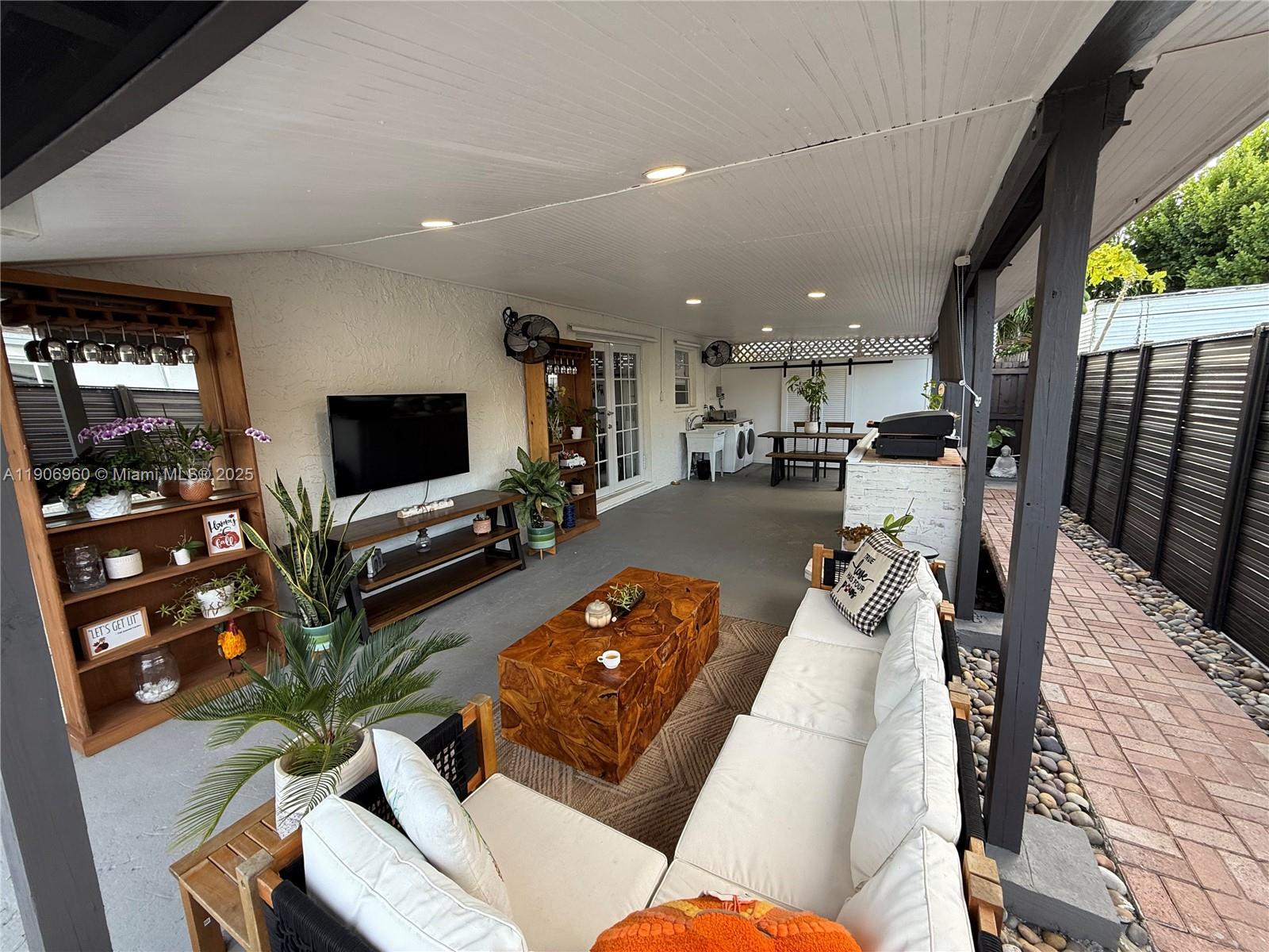 20912 Southwest 125th Avenue Road Miami, FL 33177 - Photo 19 of 25 a living room with furniture and a flat screen tv