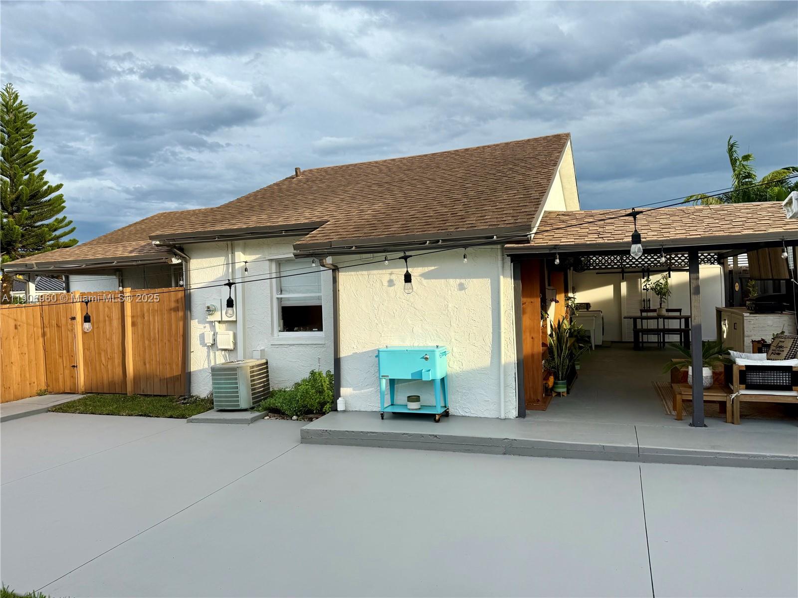 20912 Southwest 125th Avenue Road Miami, FL 33177 - Photo 23 of 25 a front view of a house with basket ball court and garage