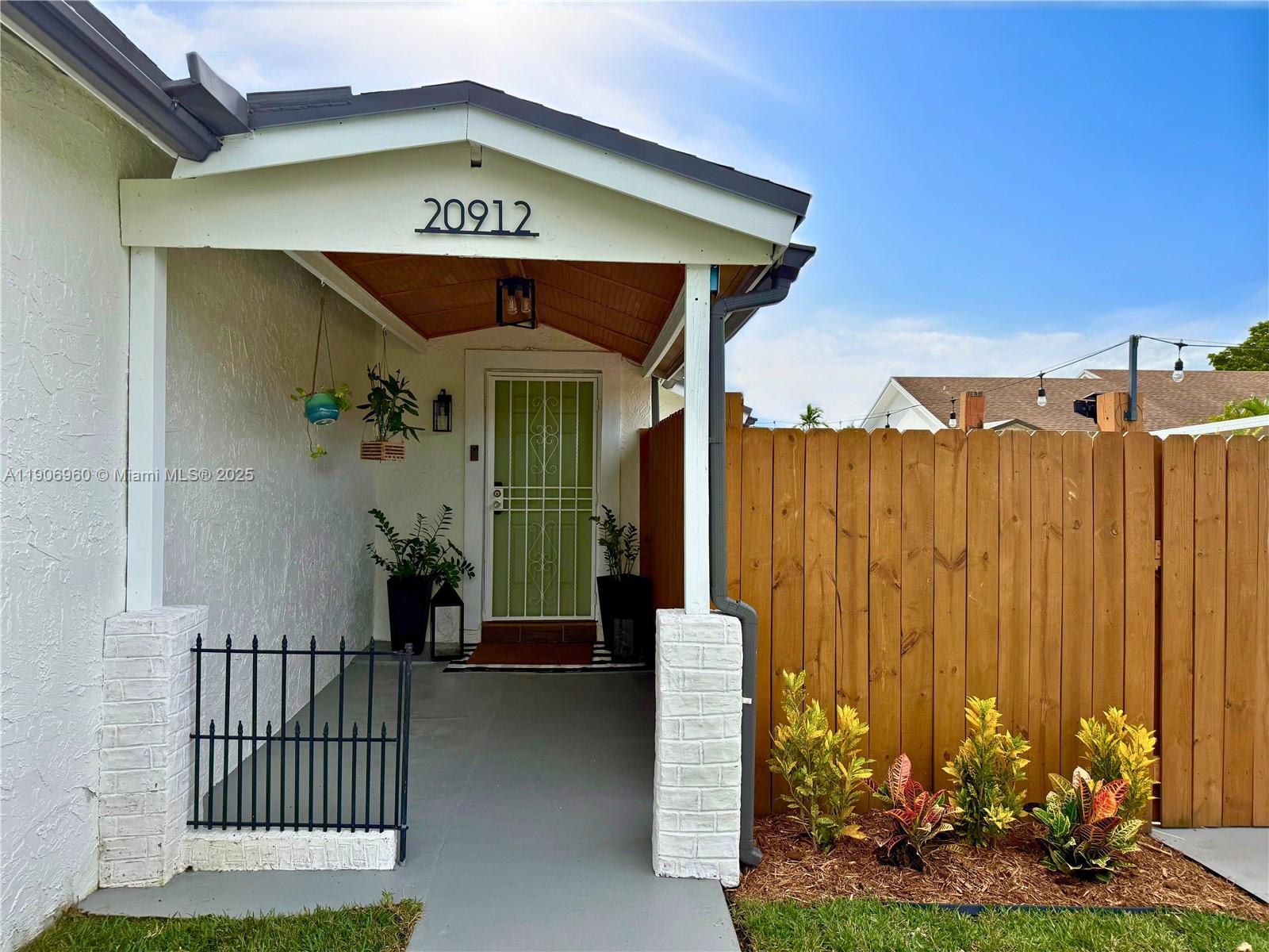 20912 Southwest 125th Avenue Road Miami, FL 33177 - Photo 3 of 25 a view of a entryway gate of the house