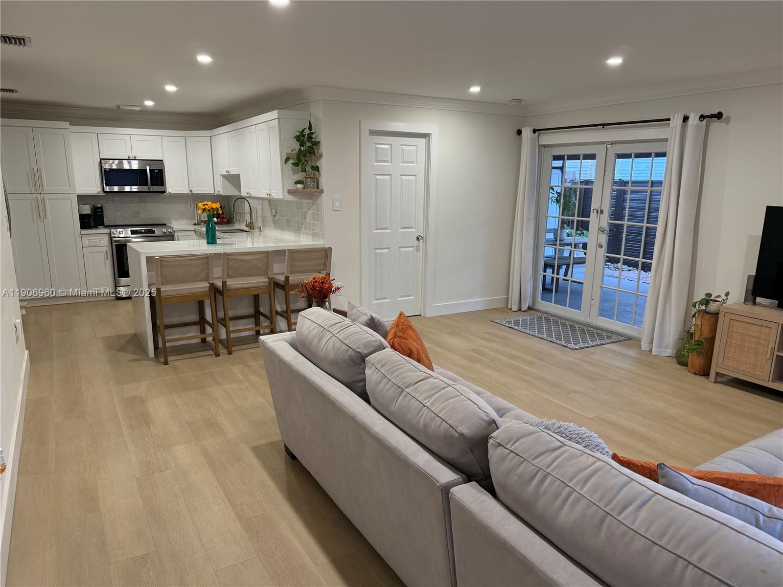 20912 Southwest 125th Avenue Road Miami, FL 33177 - Photo 5 of 25 a living room with kitchen furniture and a flat screen tv