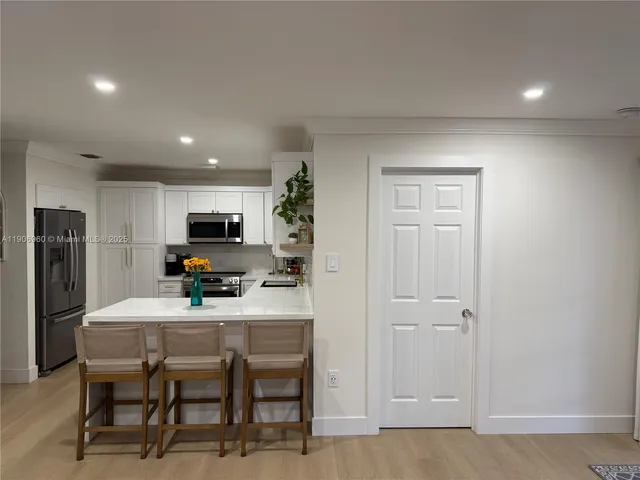 a kitchen with a table and chairs in it