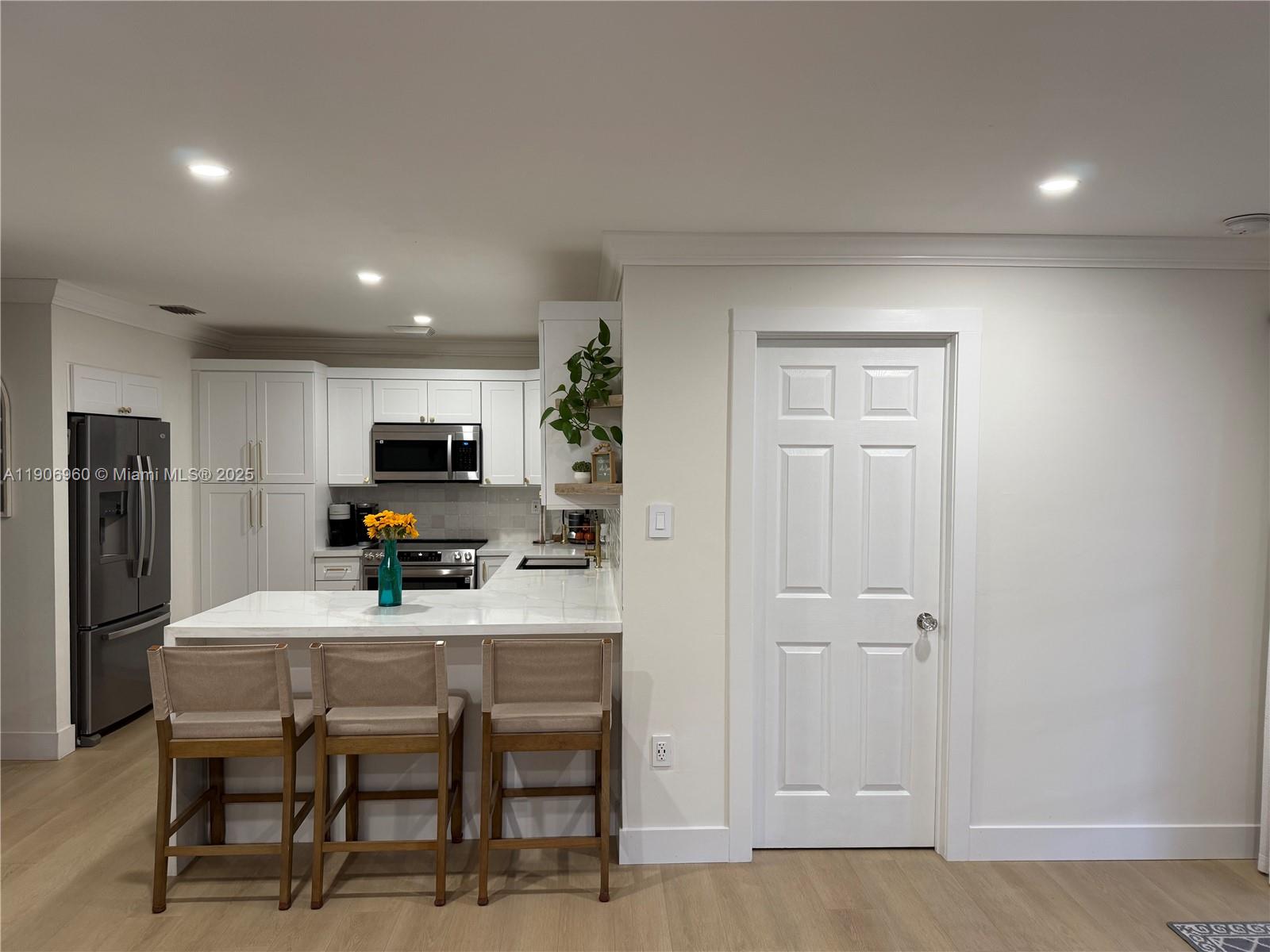 20912 Southwest 125th Avenue Road Miami, FL 33177 - Photo 6 of 25 a kitchen with a table and chairs in it