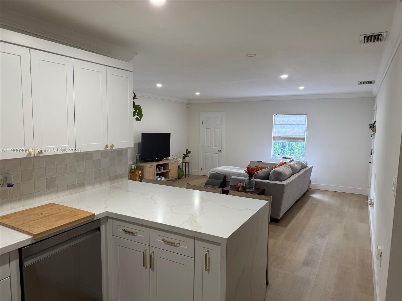 20912 Southwest 125th Avenue Road Miami, FL 33177 - Photo 9 of 25 a living room with furniture and a flat screen tv