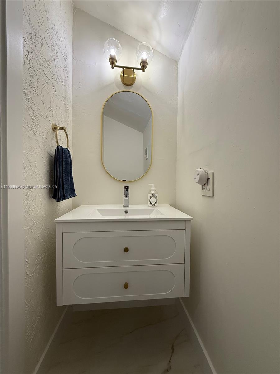 20912 Southwest 125th Avenue Road Miami, FL 33177 - Photo 10 of 25 a bathroom with a sink and a mirror