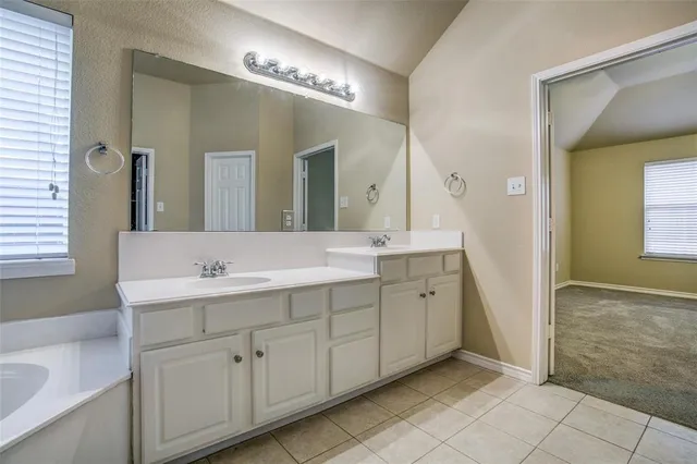 a spacious bathroom with a double vanity sink mirror and