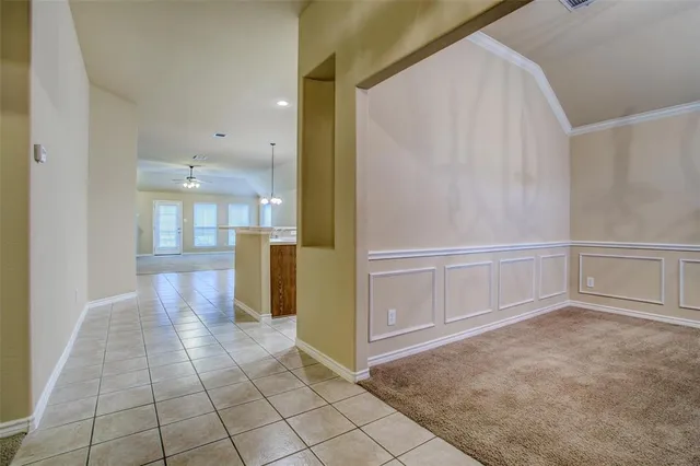 a view of a refrigerator in kitchen and a window