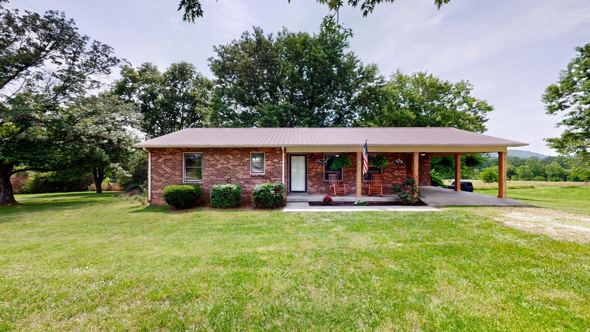 3460 Bradyville Road Readyville, TN 37149 - Photo 1 of 42 a front view of a house with swimming pool having outdoor seating