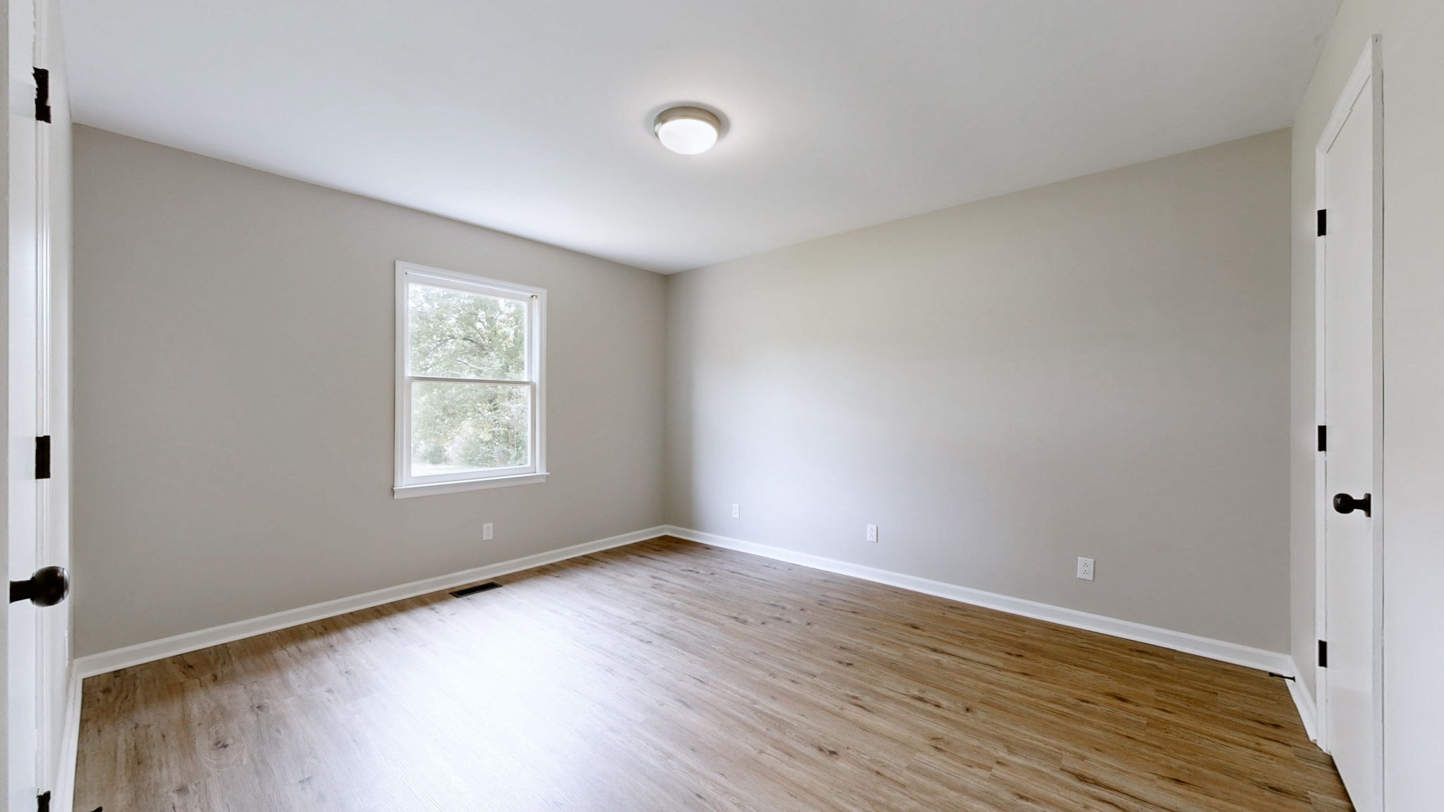 3460 Bradyville Road Readyville, TN 37149 - Photo 12 of 42 an empty room with wooden floor and windows