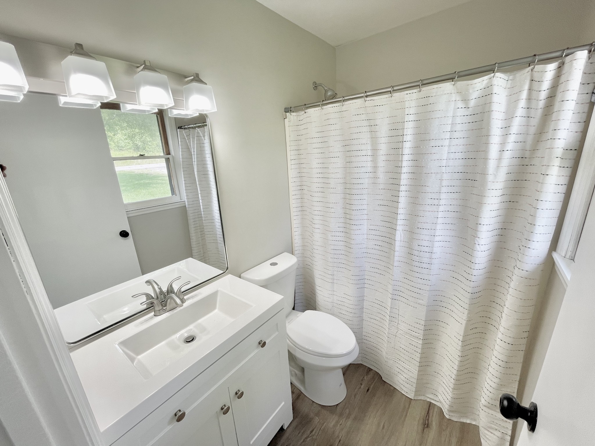 3460 Bradyville Road Readyville, TN 37149 - Photo 14 of 42 a bathroom with a sink a toilet and shower curtain
