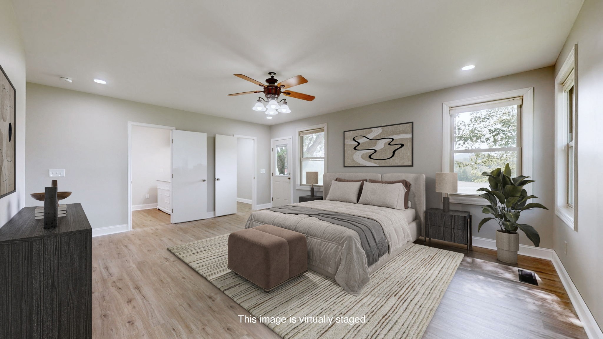 3460 Bradyville Road Readyville, TN 37149 - Photo 19 of 42 a spacious bedroom with a large bed and a chandelier