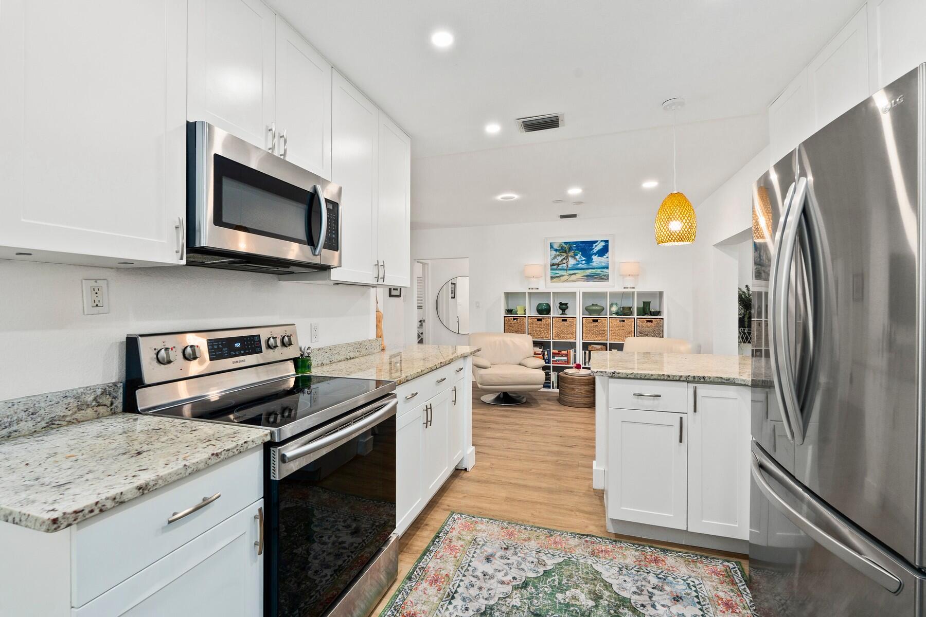 609 South 9th Street Fort Pierce, FL 34950 - Photo 11 of 39 a kitchen with stainless steel appliances granite countertop a refrigerator stove and sink