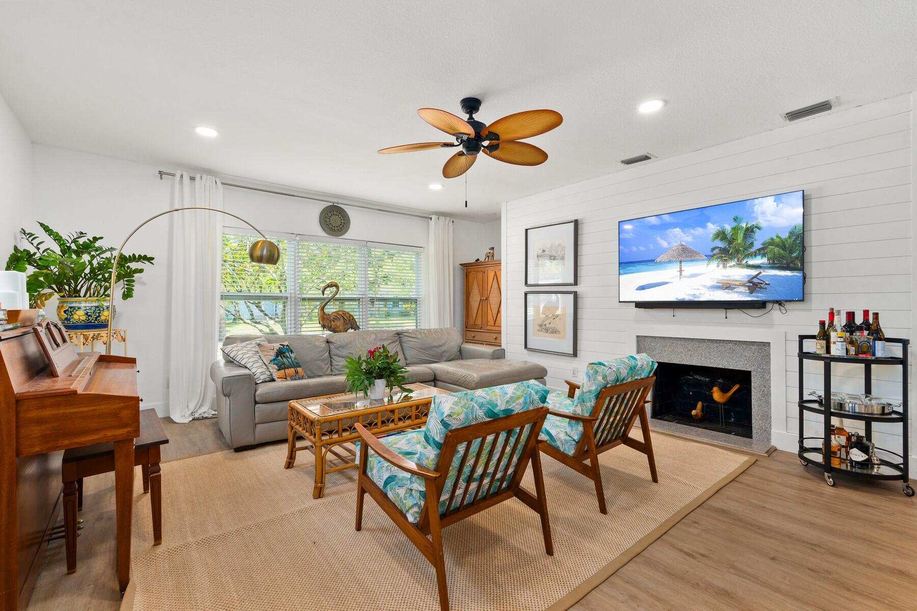 609 South 9th Street Fort Pierce, FL 34950 - Photo 6 of 39 a living room with furniture a fireplace and a flat screen tv