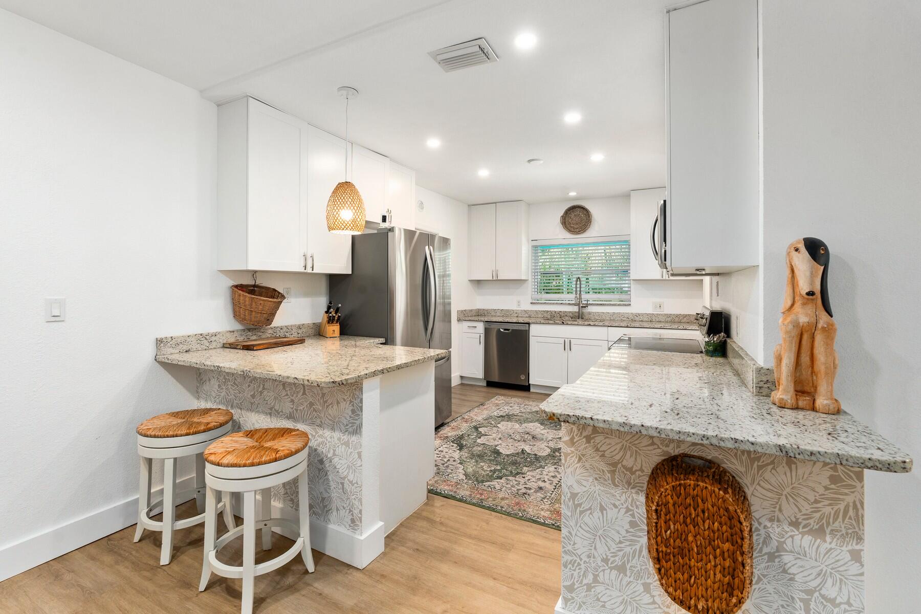 609 South 9th Street Fort Pierce, FL 34950 - Photo 10 of 39 a kitchen with kitchen island granite countertop a sink and a stove