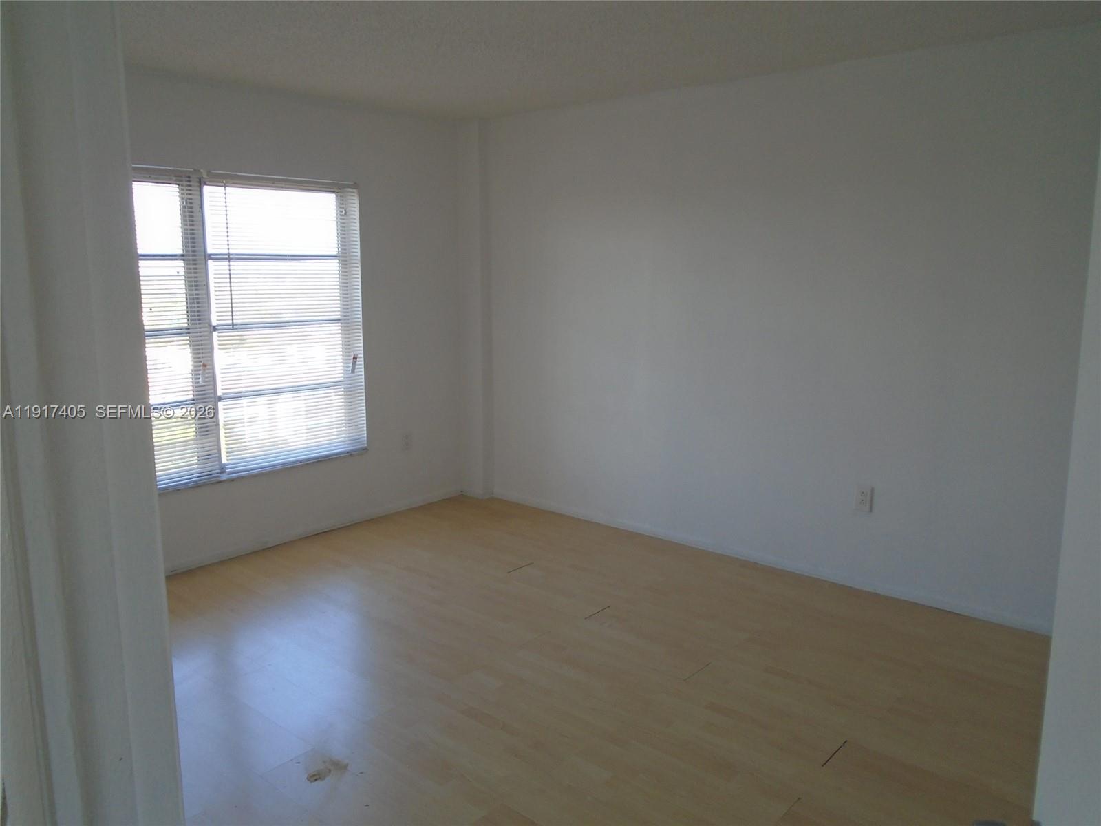 4174 Inverrary Drive, Unit 1003 Lauderhill, FL 33319 - Photo 19 of 30 an empty room with a window