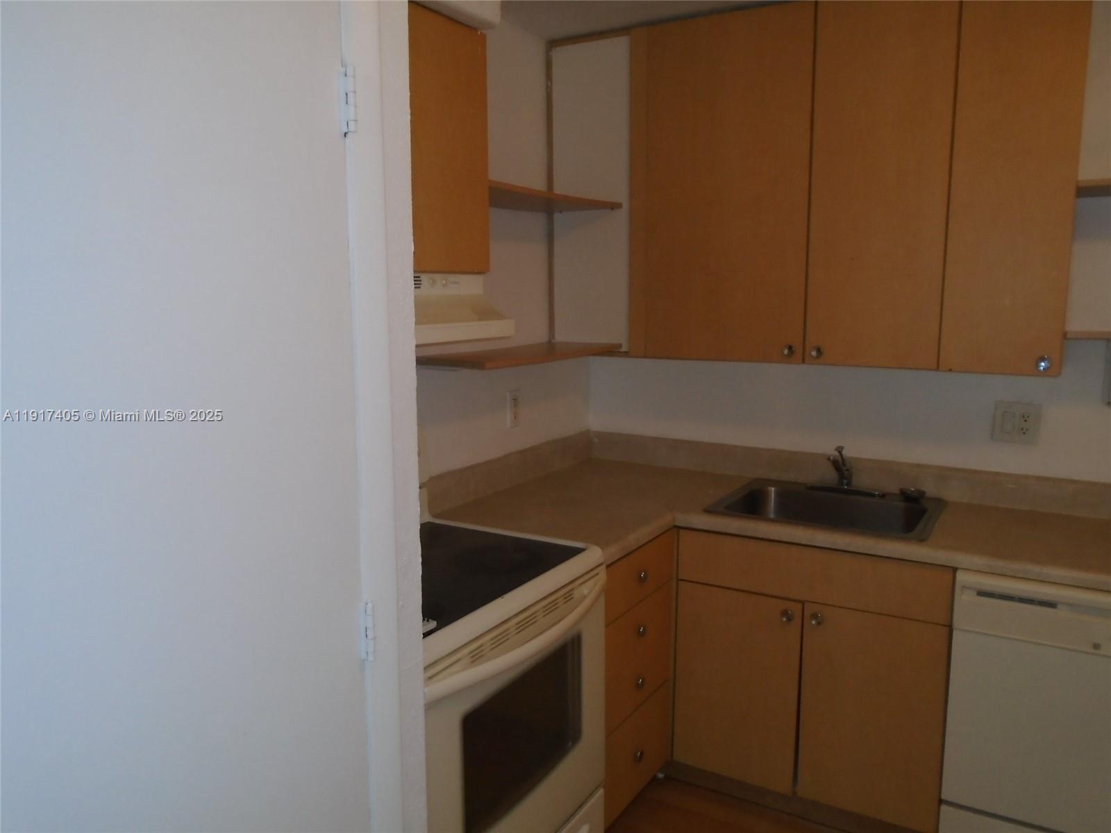 4174 Inverrary Drive, Unit 1003 Lauderhill, FL 33319 - Photo 24 of 28 a kitchen with a sink and cabinets