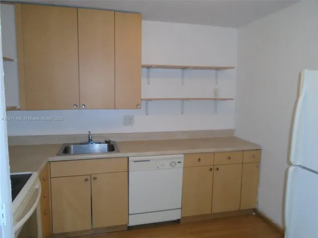a view of cabinets with wooden floor