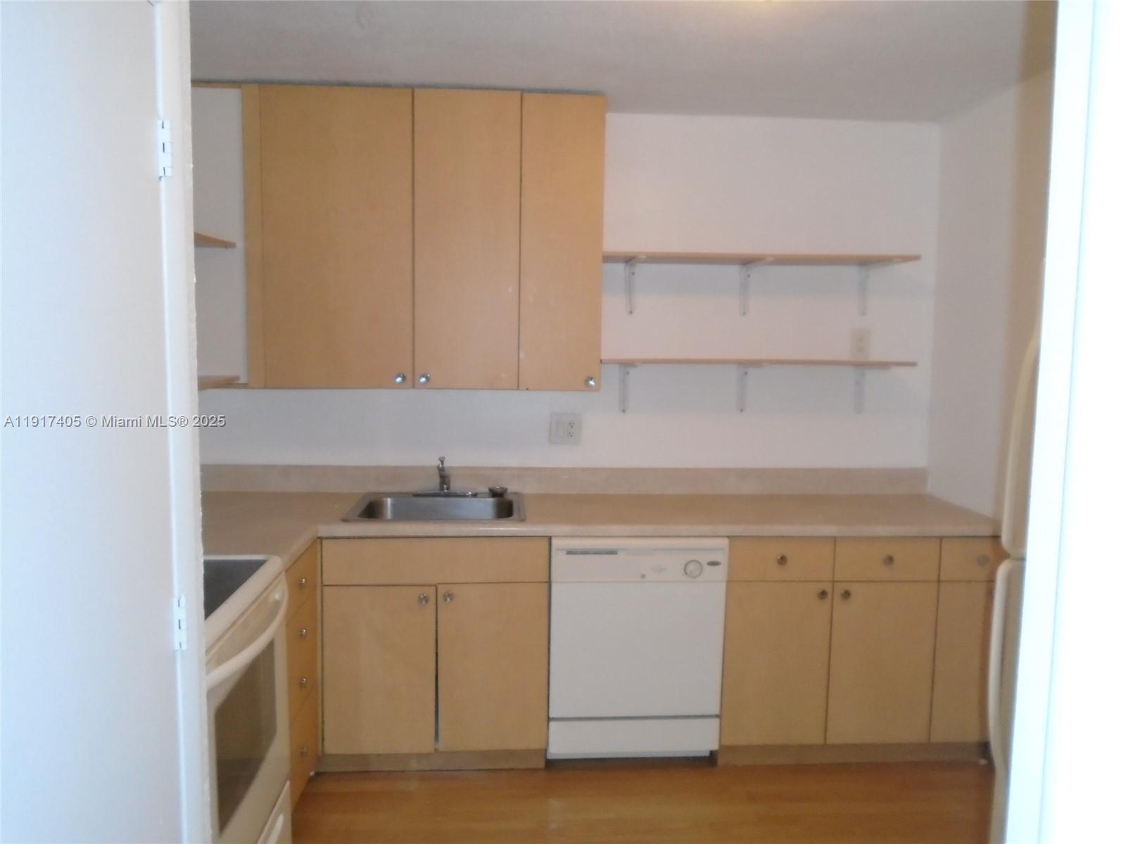 4174 Inverrary Drive, Unit 1003 Lauderhill, FL 33319 - Photo 26 of 28 a view of cabinets a sink and dishwasher in a white cabinet