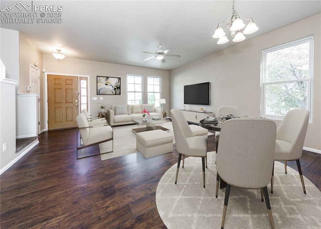 7818 Sandy Springs Point Fountain, CO 80817 - Photo 12 of 46 a living room with furniture a chandelier and a flat screen tv
