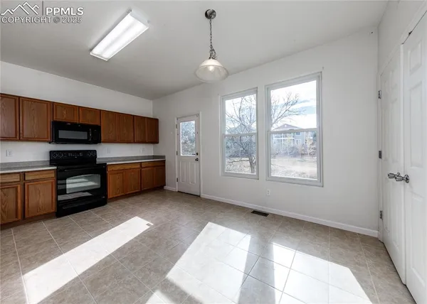 a view of a kitchen with a stove cabinets and a kitchen