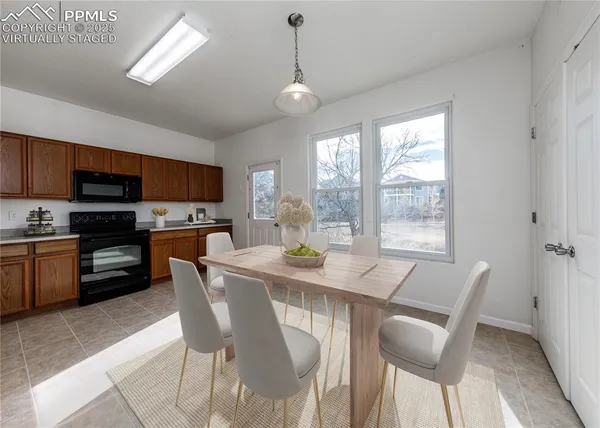 a view of a dining room with furniture window and outside view