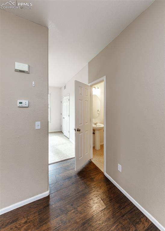 7818 Sandy Springs Point Fountain, CO 80817 - Photo 20 of 46 a view of a kitchen with a refrigerator and wooden floor