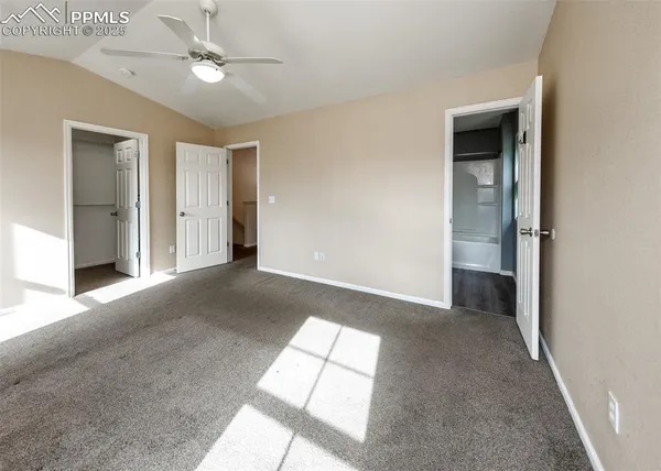 a view of empty room with windows and ceiling fan