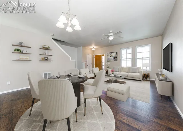 a living room with furniture or chandelier and a wooden floor