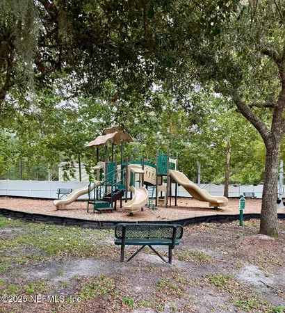 a view of outdoor space with playground and green space