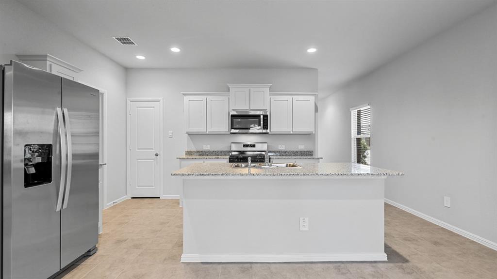 120 Mojave Road Boyd, TX 76023 - Photo 2 of 40 a kitchen with stainless steel appliances granite countertop a stove a sink and a refrigerator
