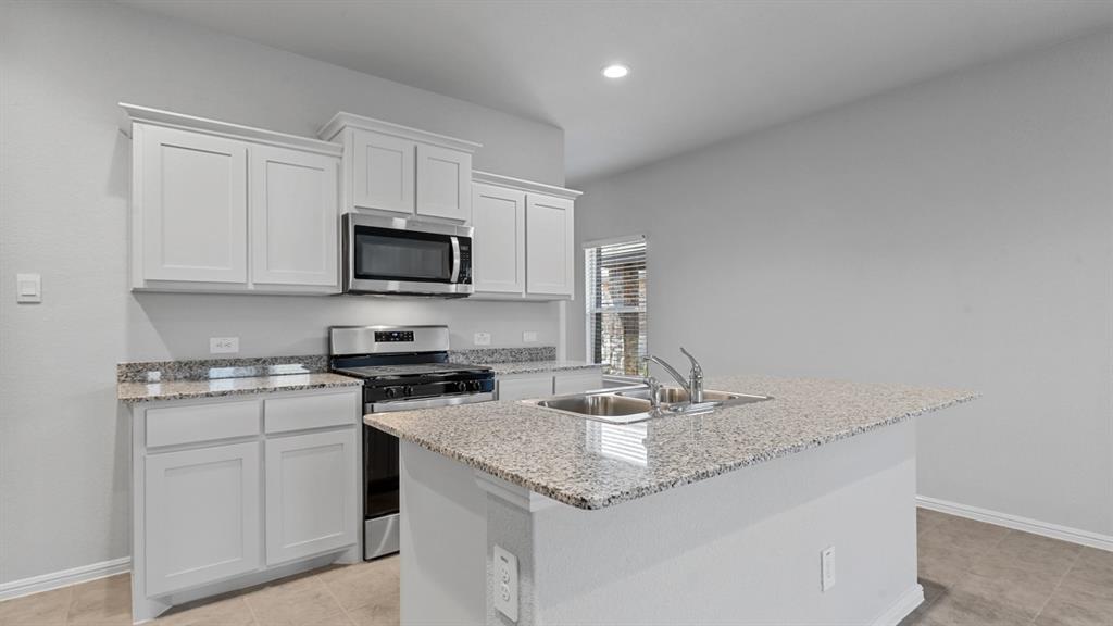 120 Mojave Road Boyd, TX 76023 - Photo 3 of 40 a kitchen with stainless steel appliances granite countertop a sink stove and microwave