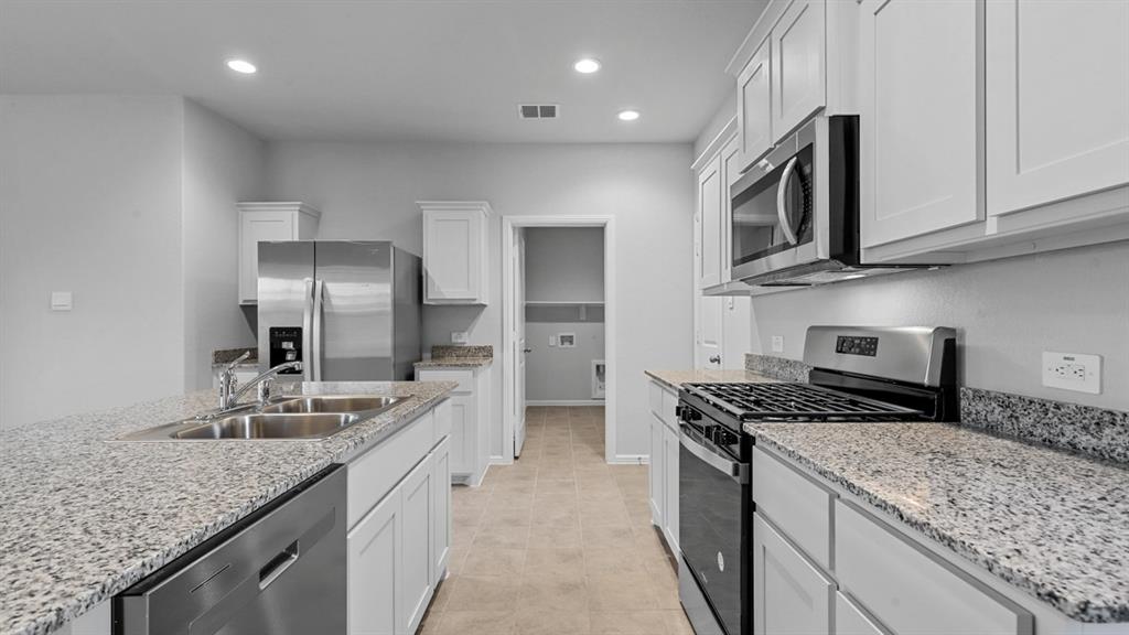 120 Mojave Road Boyd, TX 76023 - Photo 5 of 40 a kitchen with stainless steel appliances granite countertop a sink stove and refrigerator